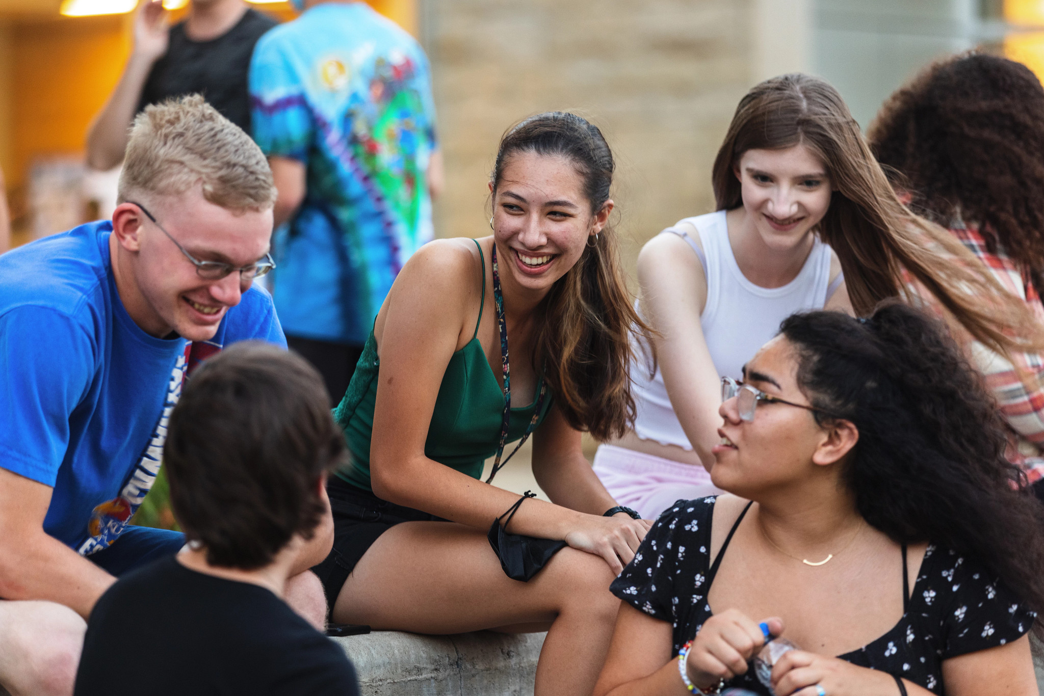 Photograph of several students talking and smiling.